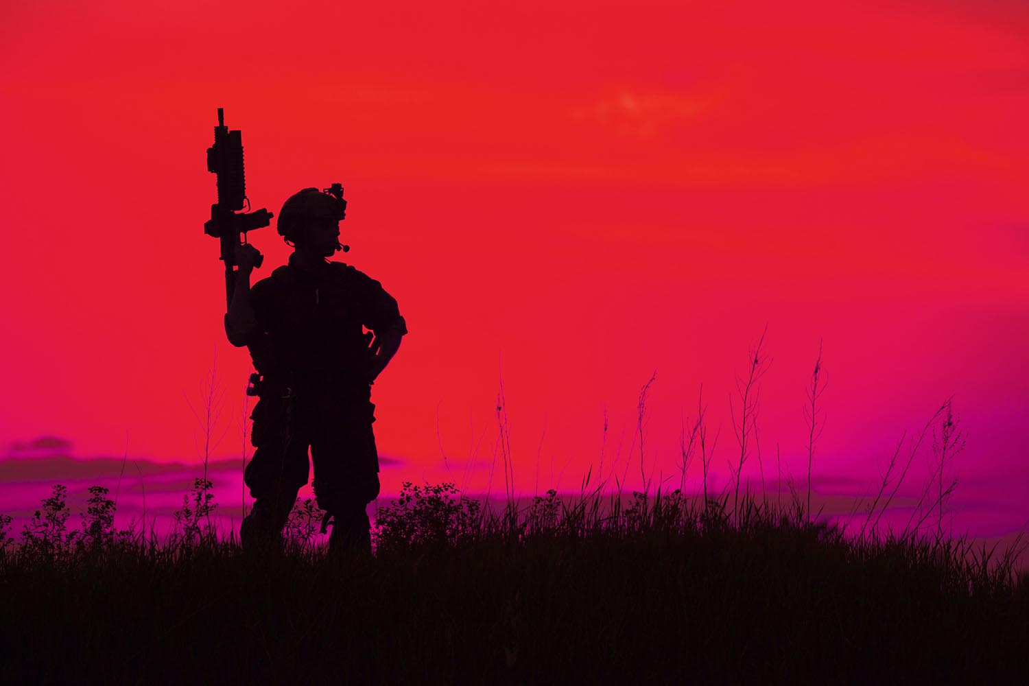 Silhouette of military soldier or officer with weapons at sunset