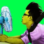 Summer heat, business man use fans to cool down